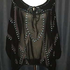 Sheer black blouse with embroidered details